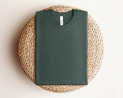 Bella+Canvas 3001 — Folded on Rattan mockup in Heather Forest