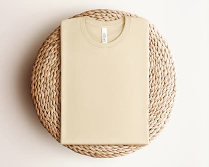 Bella+Canvas 3001 — Folded on Rattan mockup in Heather Soft Cream