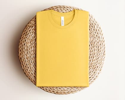 Bella+Canvas 3001 — Folded on Rattan mockup in Heather Yellow Gold