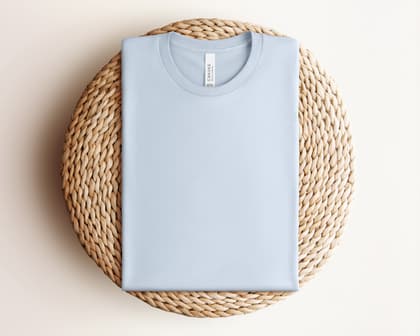 Bella+Canvas 3001 — Folded on Rattan mockup in Light Blue