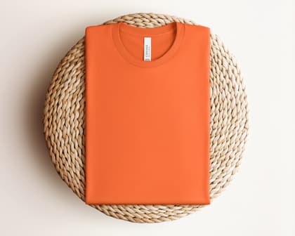 Bella+Canvas 3001 — Folded on Rattan mockup in Orange