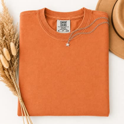 Comfort Colors® 1717 — Folded with Props mockup in Burnt Orange