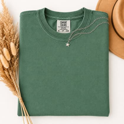 Comfort Colors® 1717 — Folded with Props mockup in Grass