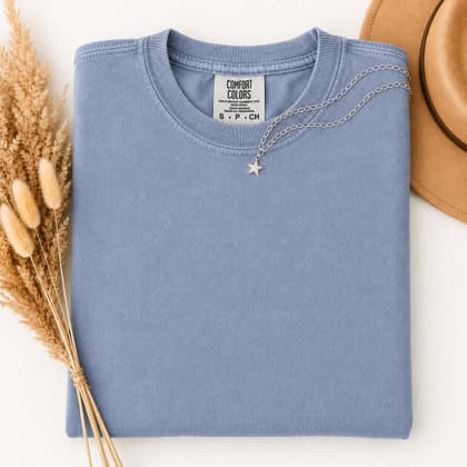 Comfort Colors® 1717 — Folded with Props mockup in Washed Denim
