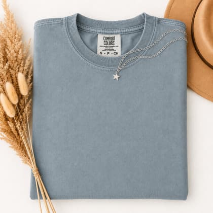 Comfort Colors® 1717 — Folded with Props mockup in Ice Blue