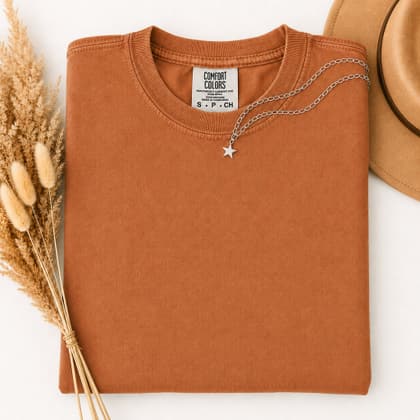 Comfort Colors® 1717 — Folded with Props mockup in Yam