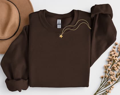 Gildan 18000 Sweatshirt — Folded with Props mockup in Dark Chocolate