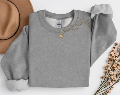 Gildan 18000 Sweatshirt — Folded with Props mockup in Graphite Heather