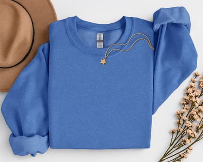 Gildan 18000 Sweatshirt — Folded with Props mockup in Heather Sport Royal