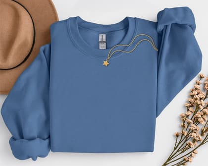 Gildan 18000 Sweatshirt — Folded with Props mockup in Indigo Blue