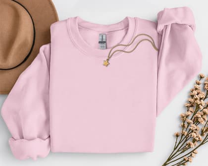 Gildan 18000 Sweatshirt — Folded with Props mockup in Light Pink