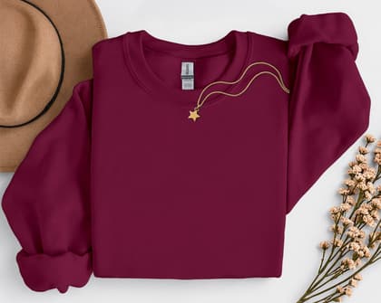 Gildan 18000 Sweatshirt — Folded with Props mockup in Maroon