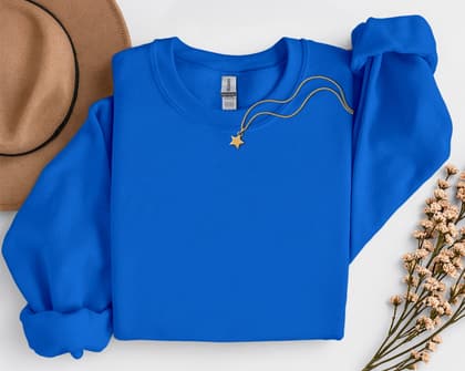 Gildan 18000 Sweatshirt — Folded with Props mockup in Royal