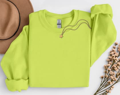 Gildan 18000 Sweatshirt — Folded with Props mockup in Safety Green