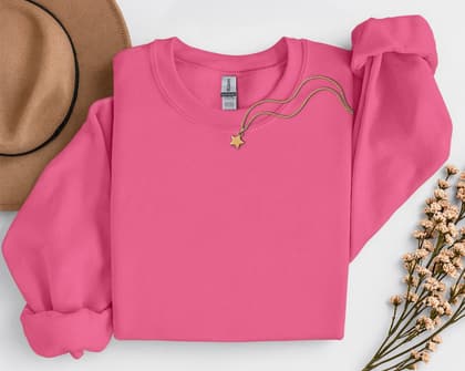 Gildan 18000 Sweatshirt — Folded with Props mockup in Safety Pink
