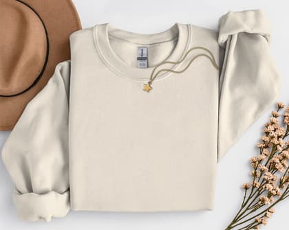 Gildan 18000 Sweatshirt — Folded with Props mockup in Sand
