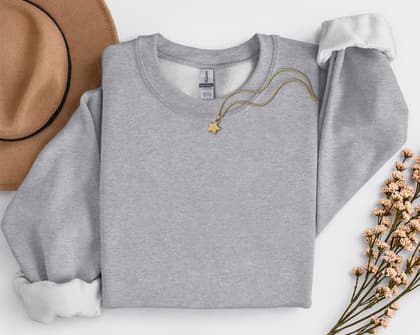 Gildan 18000 Sweatshirt — Folded with Props mockup in Sport Grey